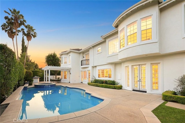 2786 E California Blvd, Pasadena, CA 91107 - pool at dusk with french doors, a patio, a pool with connected hot tub, and a pergola