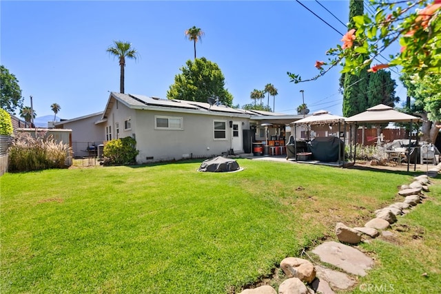7430 Dunkirk Ave, Highland, CA 92346 - rear view of property with a gazebo, solar panels, a patio area, a fenced backyard, and stucco siding
