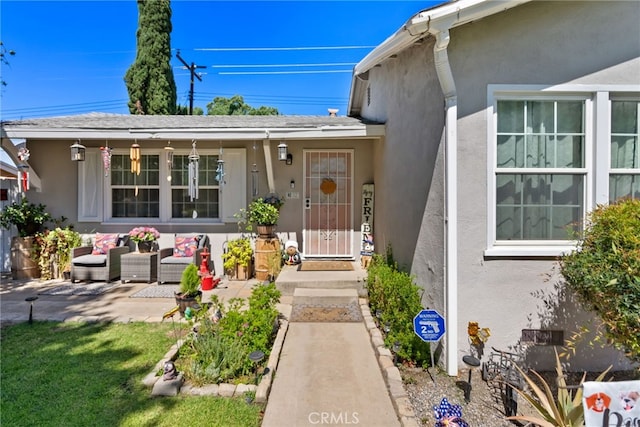 7430 Dunkirk Ave, Highland, CA 92346 - doorway to property featuring stucco siding and an outdoor living space