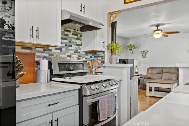 7430 Dunkirk Ave, Highland, CA 92346 - kitchen with under cabinet range hood, stainless steel electric range oven, a ceiling fan, tasteful backsplash, and wood finished floors