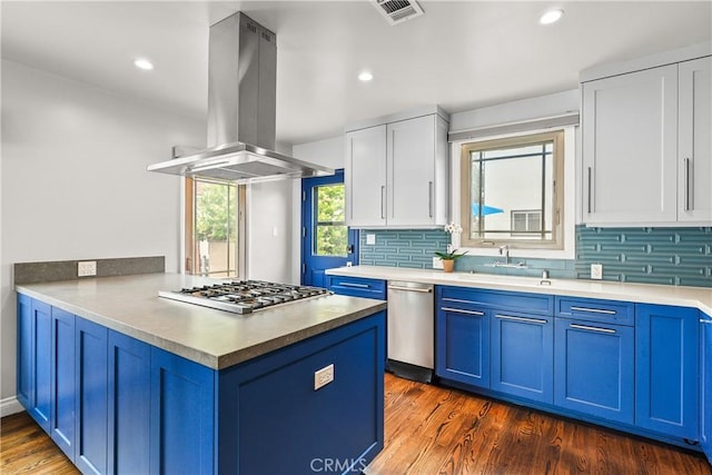 6557 Clybourn Ave, North Hollywood, CA 91606 - kitchen featuring island exhaust hood, appliances with stainless steel finishes, blue cabinets, a peninsula, and recessed lighting