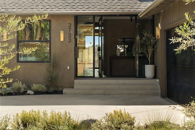 3733 Northland Dr, View Park, CA 90008 - doorway to property featuring roof with shingles and stucco siding