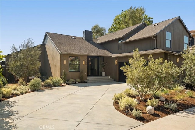 3733 Northland Dr, View Park, CA 90008 - view of front of property with a chimney, driveway, an attached garage, and a shingled roof