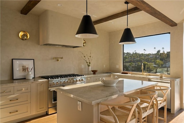 3733 Northland Dr, View Park, CA 90008 - kitchen with high end stainless steel range oven, beamed ceiling, a center island, hanging light fixtures, and white cabinetry