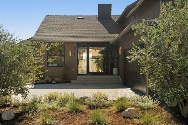 3733 Northland Dr, View Park, CA 90008 - property entrance featuring roof with shingles and a chimney