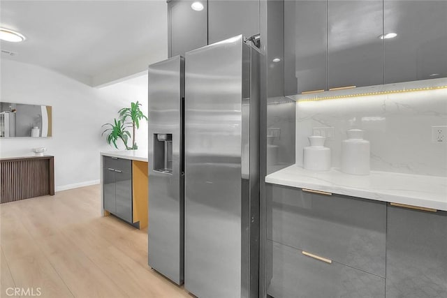 5221 Farago Ave, Temple City, CA 91780 - kitchen featuring stainless steel refrigerator with ice dispenser, gray cabinetry, modern cabinets, light wood-style floors, and light stone countertops