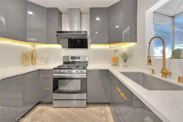 5221 Farago Ave, Temple City, CA 91780 - kitchen featuring gray cabinetry, stainless steel range with gas stovetop, wall chimney range hood, and modern cabinets