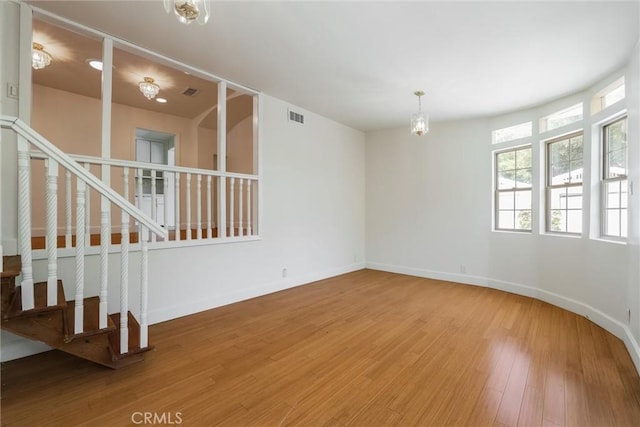 164 S Berkeley Ave, Pasadena, CA 91107 - empty room with wood finished floors, stairs, and a chandelier