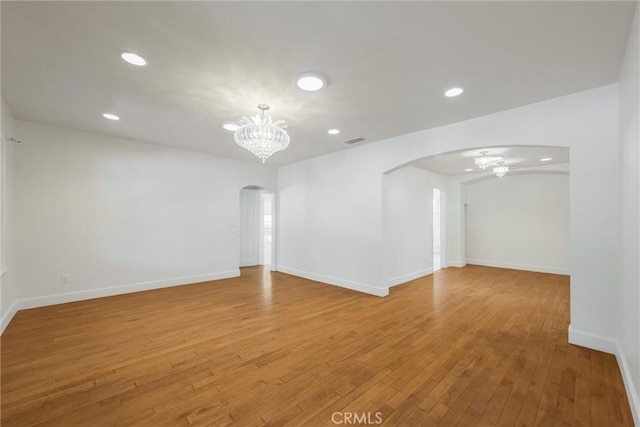 164 S Berkeley Ave, Pasadena, CA 91107 - empty room with arched walkways, a chandelier, a ceiling fan, light wood-style flooring, and recessed lighting