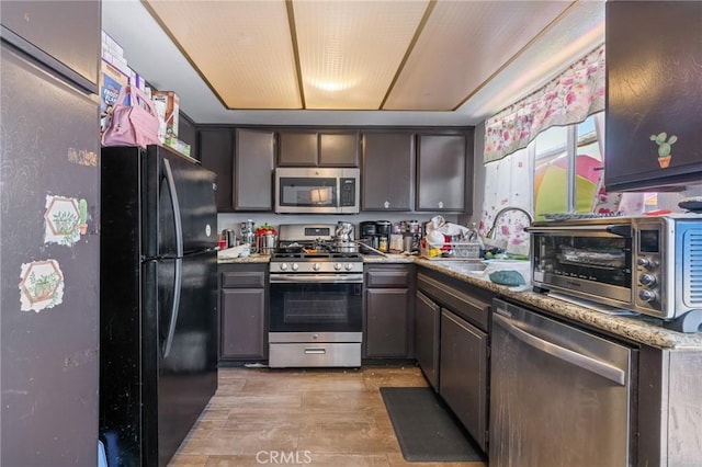 220 S Palm Ave, Santa Paula, CA 93060 - kitchen featuring stainless steel appliances, light wood-type flooring, and dark brown cabinetry