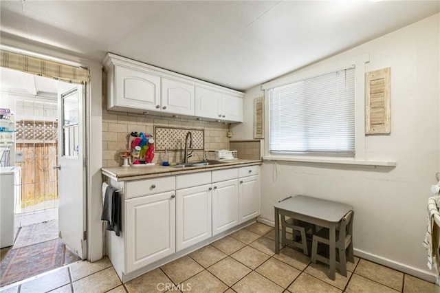 435 S Palm Ave, Santa Paula, CA 93060 - kitchen with light tile patterned floors, backsplash, light countertops, and white cabinets