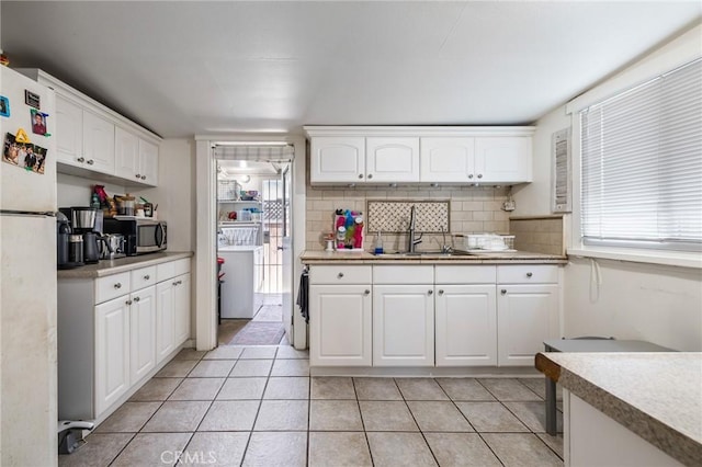 435 S Palm Ave, Santa Paula, CA 93060 - kitchen featuring freestanding refrigerator, white cabinetry, stainless steel microwave, and light countertops