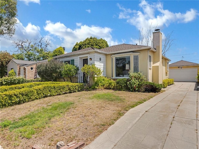 2345 22nd St, Santa Monica, CA 90405 - view of front facade featuring a chimney, stucco siding, and a detached garage