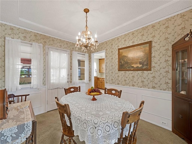 2345 22nd St, Santa Monica, CA 90405 - dining area featuring light carpet, a chandelier, a wainscoted wall, wallpapered walls, and ornamental molding