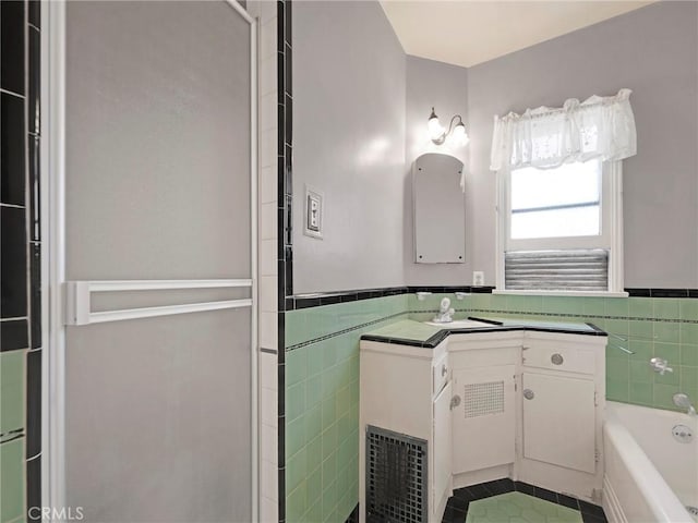 2345 22nd St, Santa Monica, CA 90405 - bathroom featuring tile walls, tile patterned flooring, vanity, a bath, and a wainscoted wall
