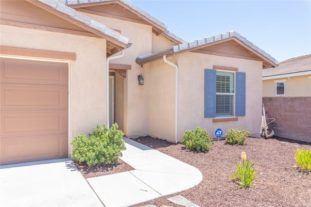 29184 Tree House, Lake Elsinore, CA 92530 - view of exterior entry featuring stucco siding and an attached garage