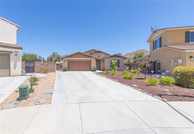 29184 Tree House, Lake Elsinore, CA 92530 - view of front facade with a gate, concrete driveway, stucco siding, and a garage