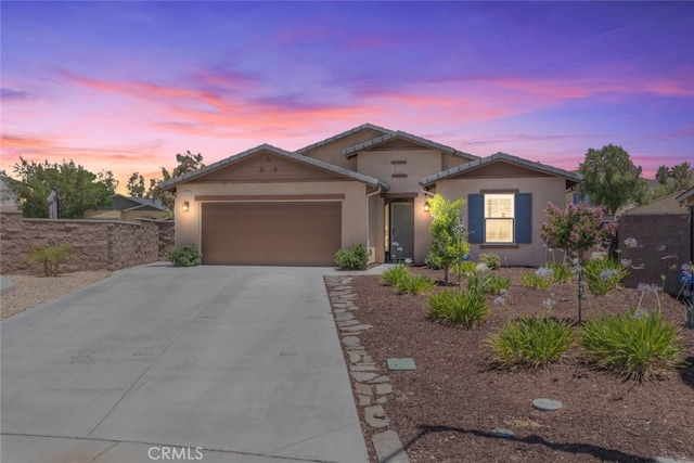 29184 Tree House, Lake Elsinore, CA 92530 - view of front of property featuring an attached garage, driveway, and stucco siding