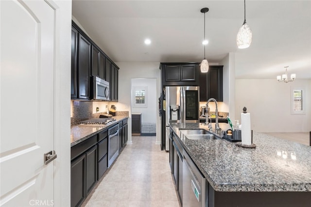 29184 Tree House, Lake Elsinore, CA 92530 - kitchen with appliances with stainless steel finishes, an island with sink, dark stone countertops, and plenty of natural light