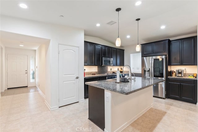 29184 Tree House, Lake Elsinore, CA 92530 - kitchen with stainless steel appliances, dark stone counters, recessed lighting, a kitchen island with sink, and pendant lighting
