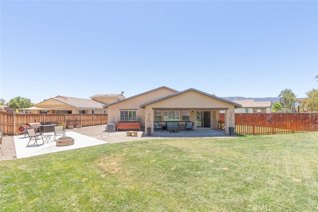 29184 Tree House, Lake Elsinore, CA 92530 - back of house featuring a fire pit, a patio, stucco siding, and a fenced backyard