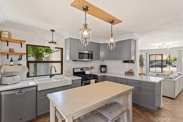 4332 Fairbrook Ln, Moorpark, CA 93021 - kitchen with gray cabinetry, stainless steel appliances, a chandelier, tasteful backsplash, and ornamental molding