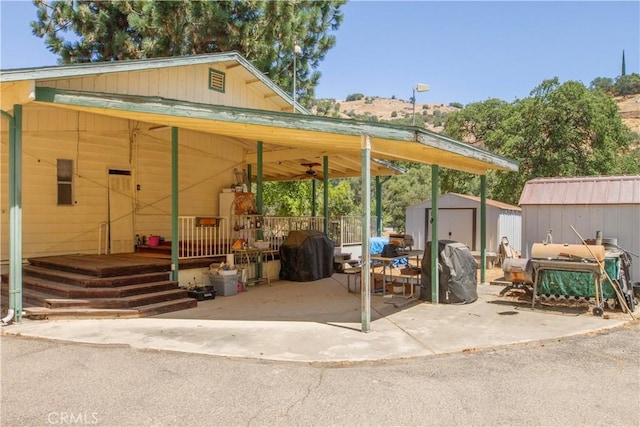 46424 Baldpate Ln, Squaw Valley, CA 93675 - covered porch with a storage shed, grilling area, and a ceiling fan