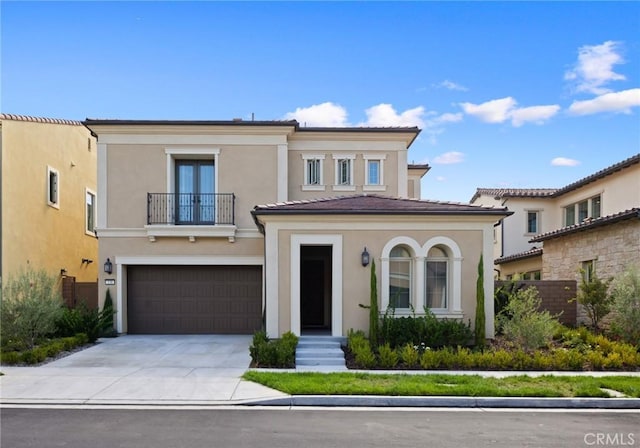 138 Jayhawk, Irvine, CA 92602 - view of front of home featuring a balcony, stucco siding, driveway, and a garage