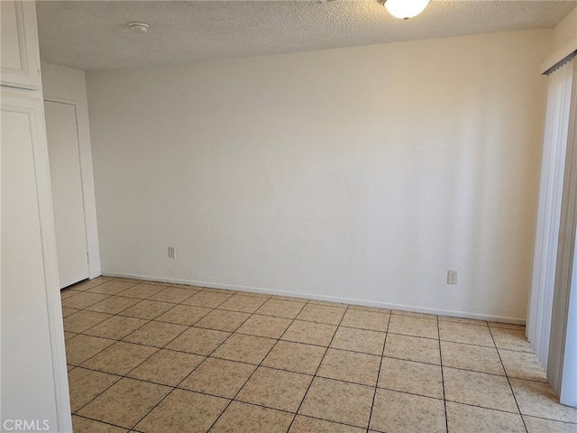7941 Midhurst Dr, Highland, CA 92346 - empty room with light tile patterned floors, a smoke detector, and a textured ceiling