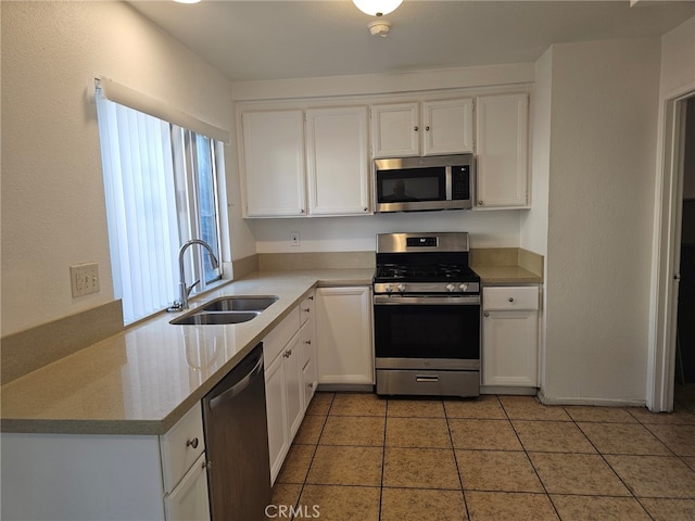 7941 Midhurst Dr, Highland, CA 92346 - kitchen with stainless steel appliances, white cabinets, light tile patterned flooring, and light countertops