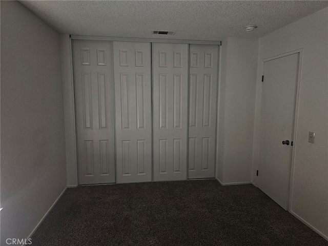 7941 Midhurst Dr, Highland, CA 92346 - unfurnished bedroom featuring dark colored carpet, a textured ceiling, and a closet