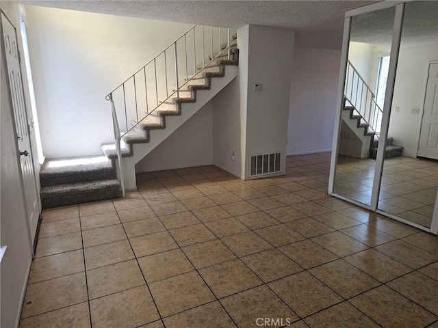 7941 Midhurst Dr, Highland, CA 92346 - entrance foyer featuring stairway, a textured ceiling, and tile patterned floors
