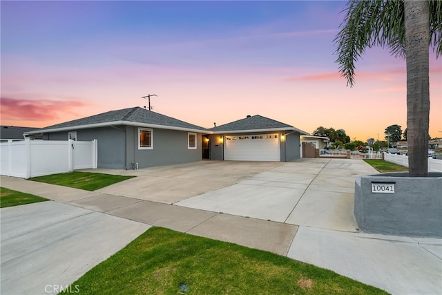 10041 Margo Ln, Westminster, CA 92683 - ranch-style home featuring an attached garage, concrete driveway, stucco siding, and roof with shingles