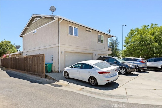 1654 E Ave, Chico, CA 95926 - view of property exterior featuring a garage and stucco siding