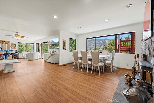 1104 Snowbird Dr, Frazier Park, CA 93225 - dining space with light wood-style flooring, recessed lighting, ceiling fan, and a wood stove