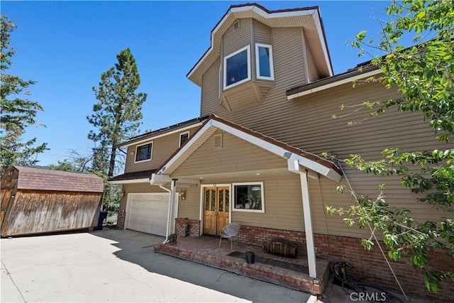 1104 Snowbird Dr, Frazier Park, CA 93225 - view of front of house featuring brick siding, concrete driveway, and a garage
