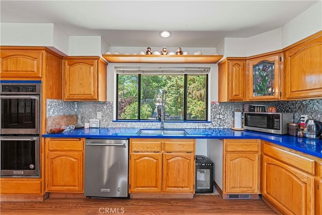 1104 Snowbird Dr, Frazier Park, CA 93225 - kitchen featuring stainless steel appliances, brown cabinets, wood finished floors, and dark countertops