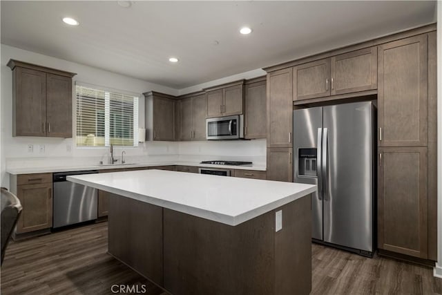 29526 Woodcreek Trl, Winchester, CA 92596 - kitchen with stainless steel appliances, a center island, dark wood finished floors, recessed lighting, and light countertops