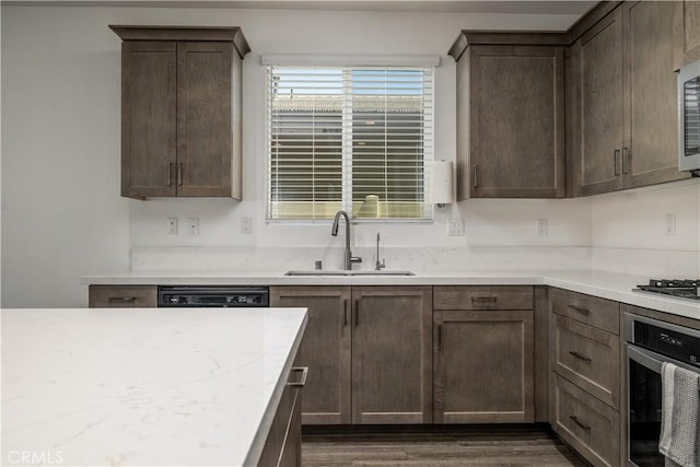 29526 Woodcreek Trl, Winchester, CA 92596 - kitchen featuring appliances with stainless steel finishes, dark wood-type flooring, dark brown cabinetry, and light stone counters