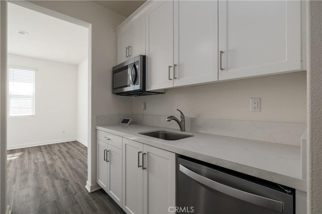 29526 Woodcreek Trl, Winchester, CA 92596 - kitchen featuring appliances with stainless steel finishes, white cabinets, dark wood-style flooring, and light stone counters