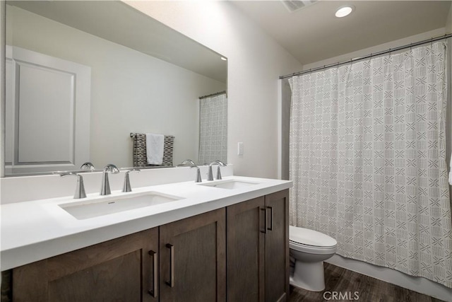 29526 Woodcreek Trl, Winchester, CA 92596 - bathroom with double vanity, wood finished floors, and recessed lighting