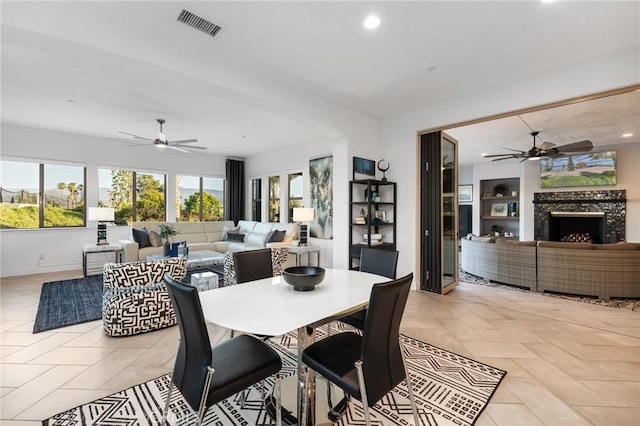 41783 Valencia Way, Temecula, CA 92592 - dining space featuring ceiling fan, a fireplace, and recessed lighting
