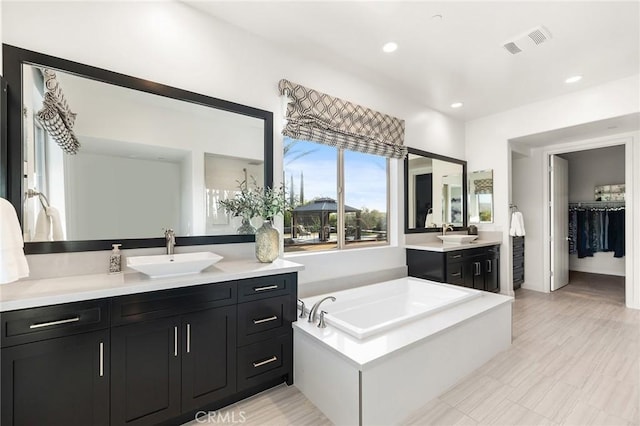 41783 Valencia Way, Temecula, CA 92592 - bathroom with vanity, a garden tub, recessed lighting, and a spacious closet