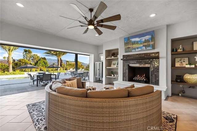 41783 Valencia Way, Temecula, CA 92592 - living room featuring built in shelves, ceiling fan, a high end fireplace, recessed lighting, and light tile patterned flooring