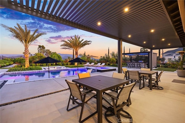 41783 Valencia Way, Temecula, CA 92592 - patio terrace at dusk featuring an in-ground hot tub, a patio, outdoor dining area, and an outdoor pool
