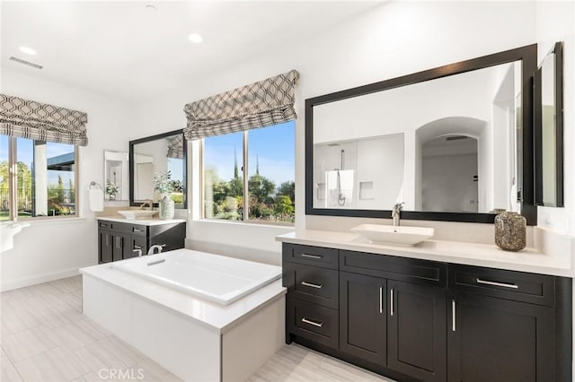 41783 Valencia Way, Temecula, CA 92592 - bathroom featuring two vanities, a bath, and recessed lighting