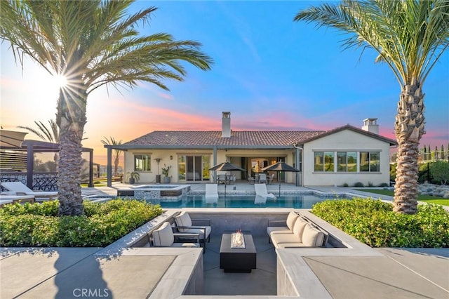 41783 Valencia Way, Temecula, CA 92592 - view of pool featuring an outdoor living space with a fire pit, a patio, and a pool with connected hot tub