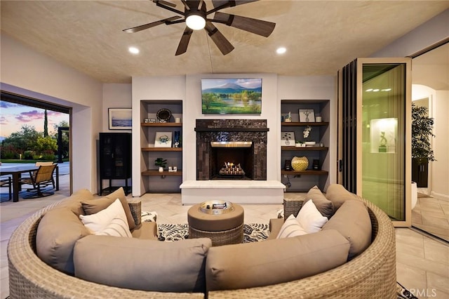 41783 Valencia Way, Temecula, CA 92592 - living room featuring built in shelves, a premium fireplace, ceiling fan, recessed lighting, and tile patterned floors