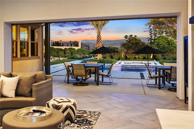 41783 Valencia Way, Temecula, CA 92592 - patio terrace at dusk featuring a hot tub, a patio, an outdoor living space, and outdoor dining area