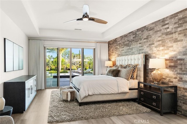 41783 Valencia Way, Temecula, CA 92592 - bedroom with access to exterior, brick wall, light wood-style floors, and a ceiling fan